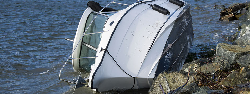 A yacht that is tipped over at a jetty